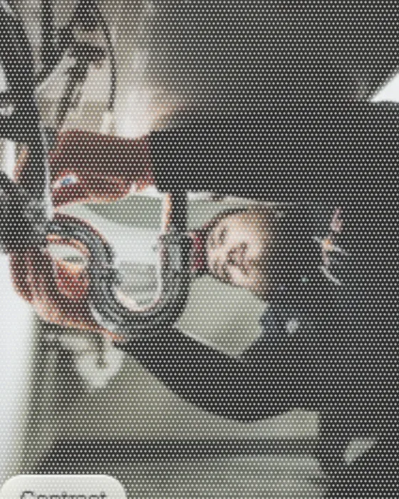 A plumber on his back under a sink, working the trap loose with a wrench.