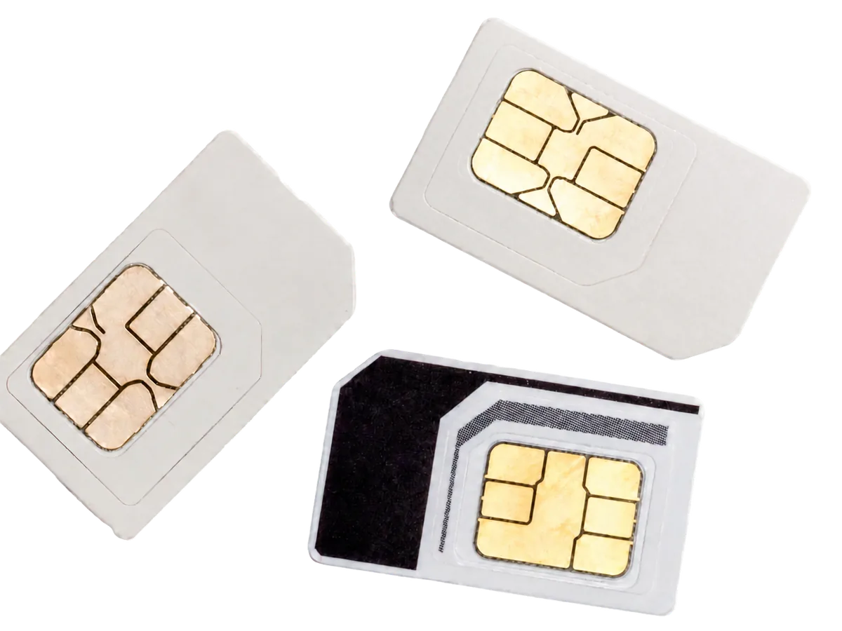 Three nano SIM cards with gold contact chips, scattered on white.